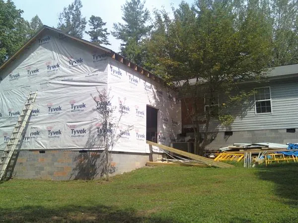 Tyvek wrapped gable on a new room addition beside an existing home in Cherry Valley